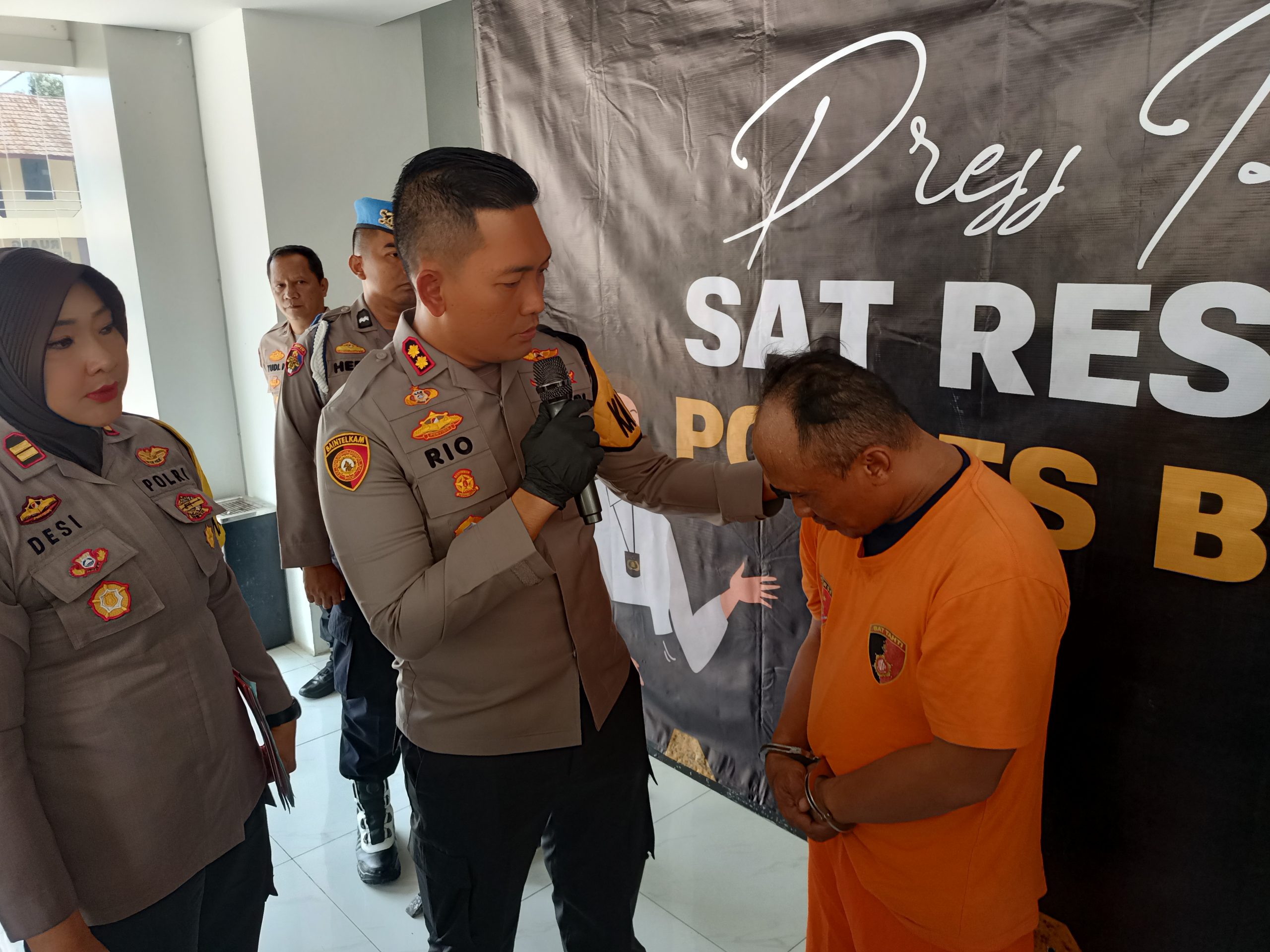 Hari alias HM, seorang Ketua RW dan anggota Ormas yang lakukan ancaman terhadap petugas Puskesmas Leuwisadeng hanya bisa tertunduk. Dia menangis di hadapan Kapolres Bogor, AKBP Rio Wahyu Anggoro (Rujukanmedia)